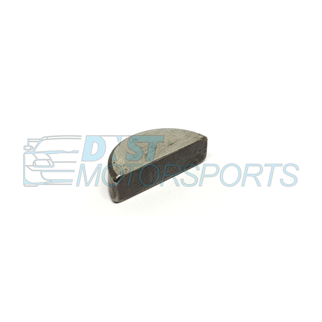 A half moon metallic object on a white background with DNST Motorsports watermark