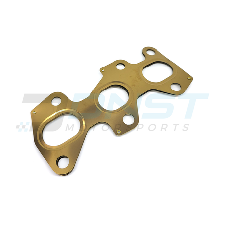 a multi layered steel engine gasket on a white background with a DNST Motorsports watermark
